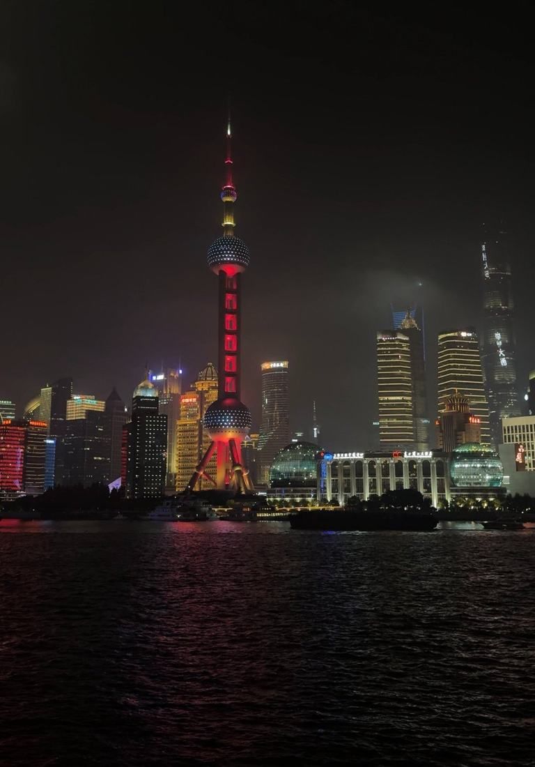 The lit-up Pudong skyline seen at night from the Bund