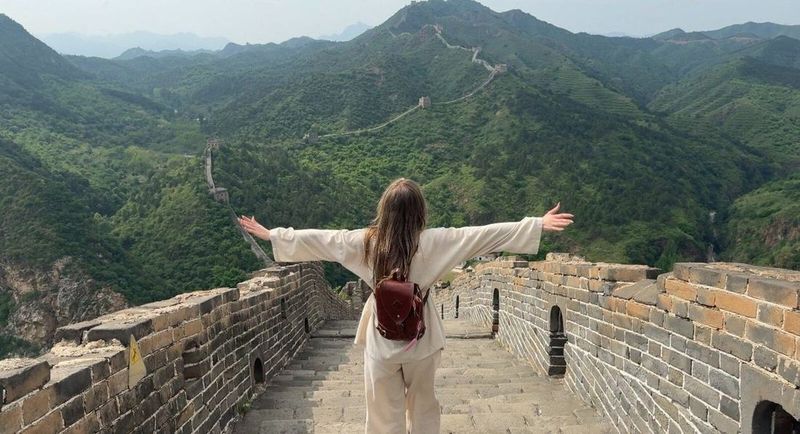 Standing on the unrestored wall at Simatai